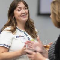 Emily Spranger talking with event attendee